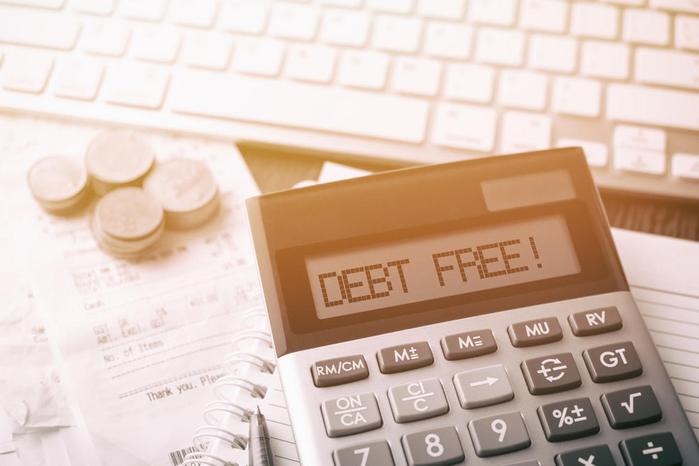 a calculator displaying the words 'Debt Free!' on it, showing that you can eliminate your debt too!