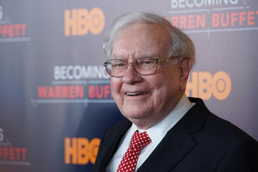 Most famous entrepreneurs: Warren Buffet stood in front of a black backdrop reading "HBO" and "Becoming Warren Buffett"