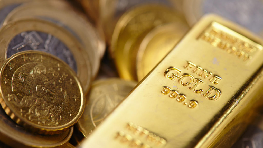gold vs platinum: a gold bar and some gold and platinum coins