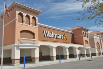 Walton family net worth: the exterior of a Walmart store on a sunny day