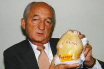 Frank Perdue: a well-dressed man in a business suit holding a Perdue chicken