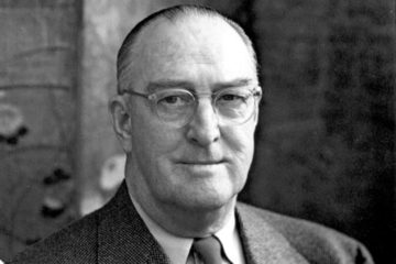 An elderly William E. Boeing dressed in a suit and tie, wearing glasses staring at the camera